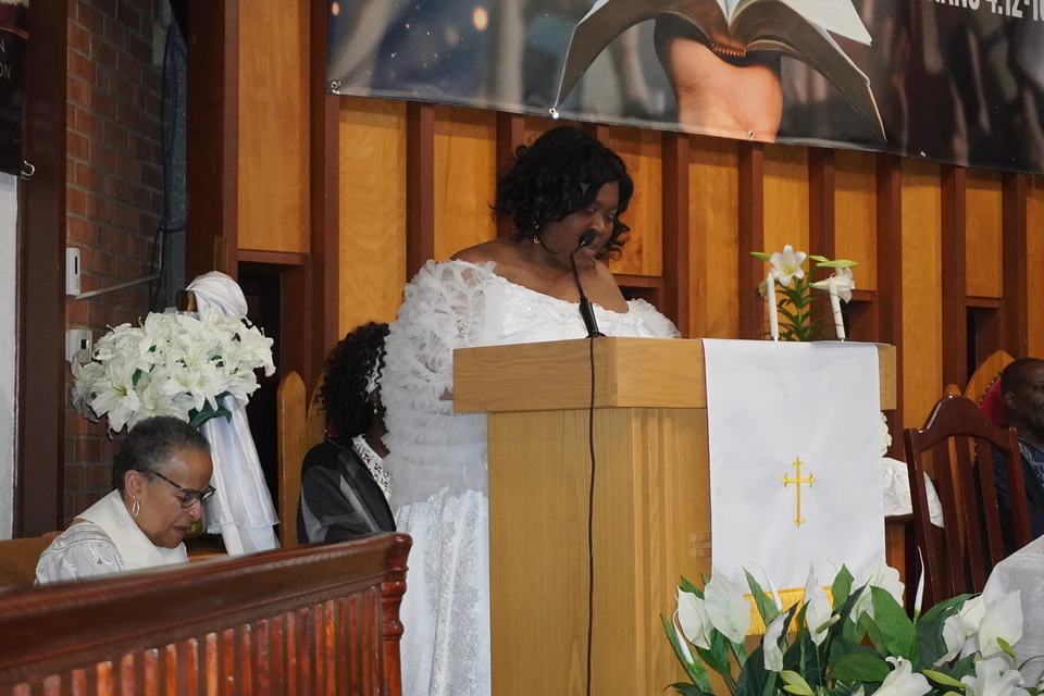 A reader preparing the next reading at the pulpit