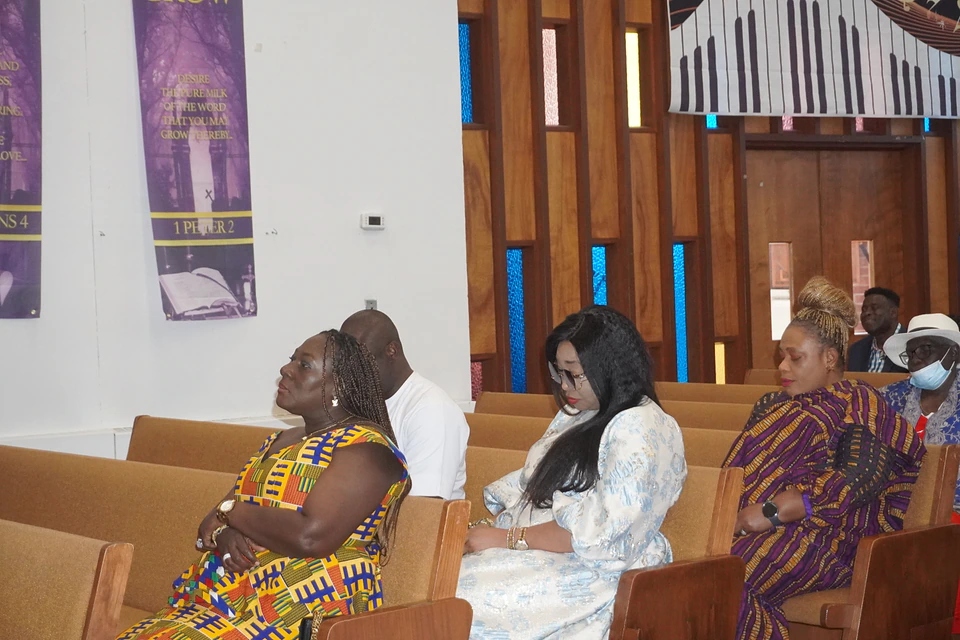 Members listening together from the sanctuary pews