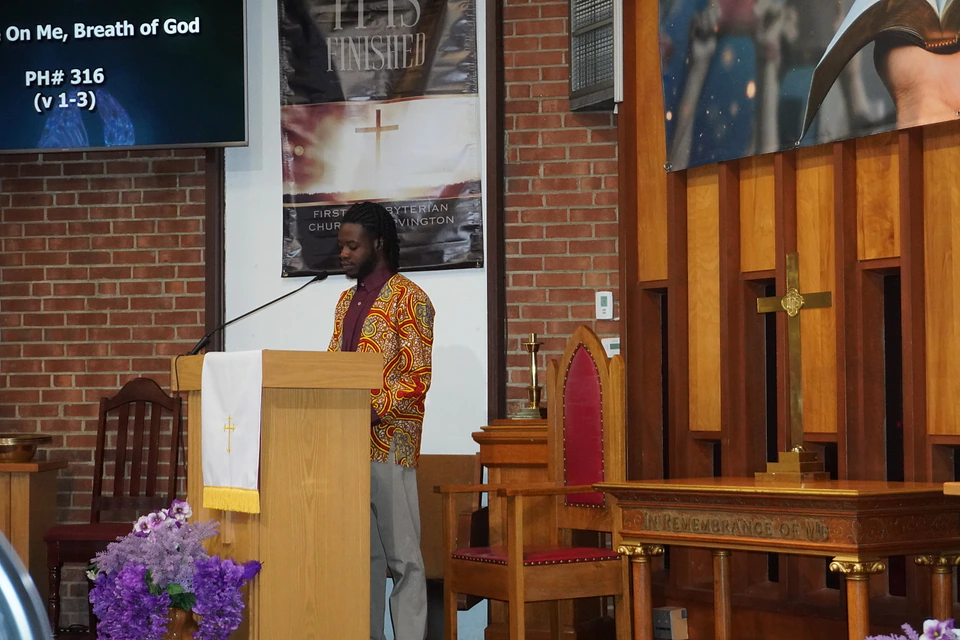 A speaker at the sanctuary pulpit during worship