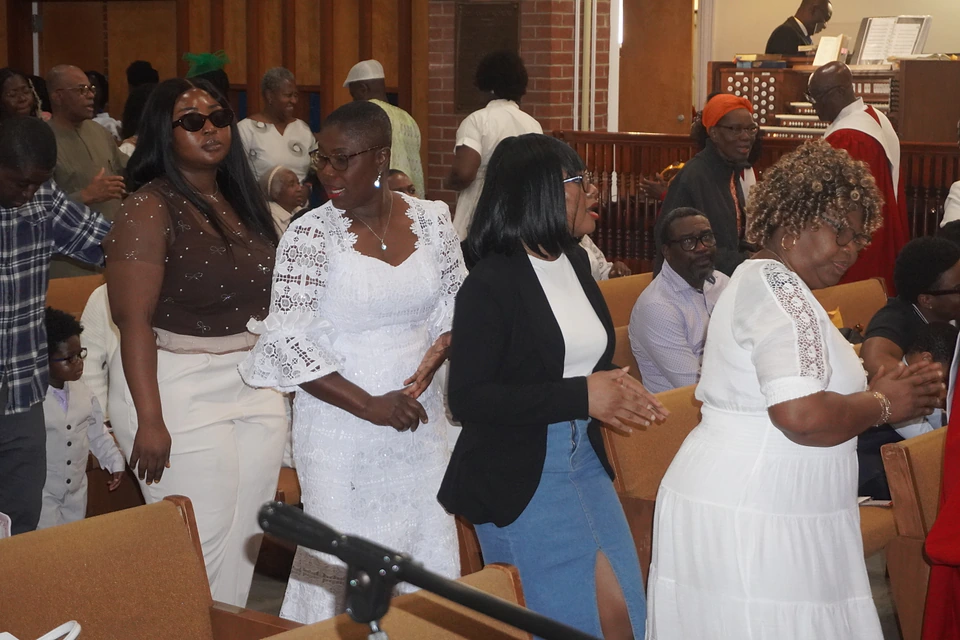 Members joining in worship from the sanctuary aisle at Easter
