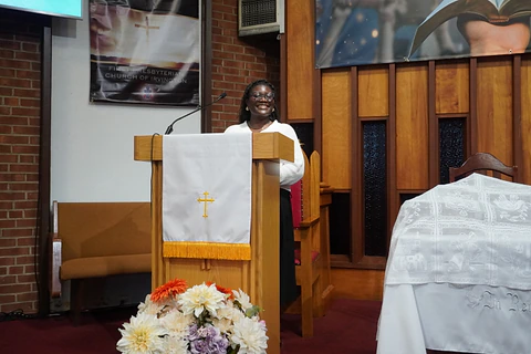 A speaker addressing the church from the pulpit