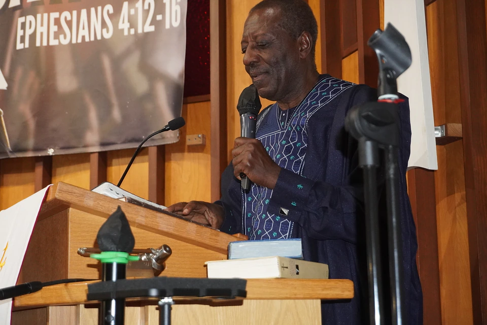 A speaker sharing the Word with a microphone
