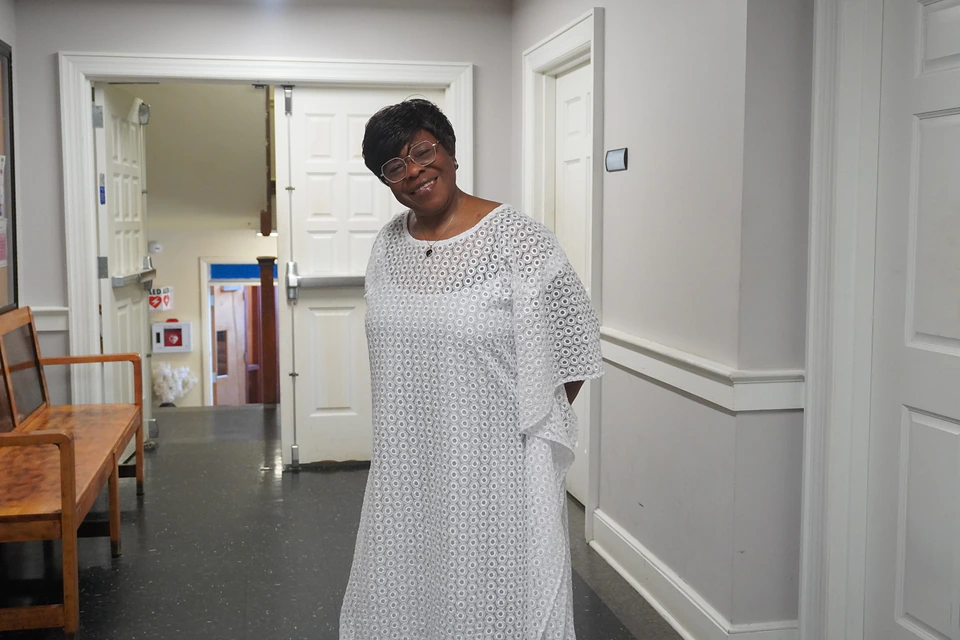 A church member standing by the entrance to the fellowship rooms