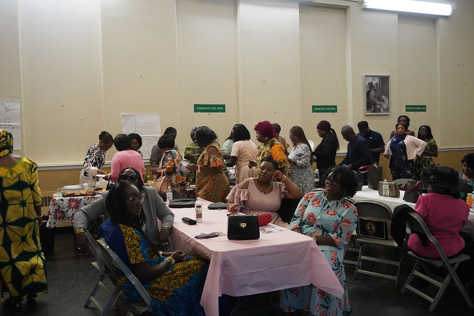 Members sharing conversation around fellowship tables