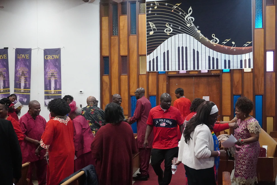 Members coming together in the sanctuary aisle