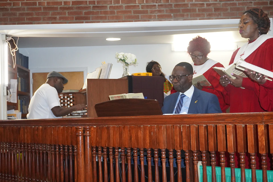 Musicians and choir members preparing their music