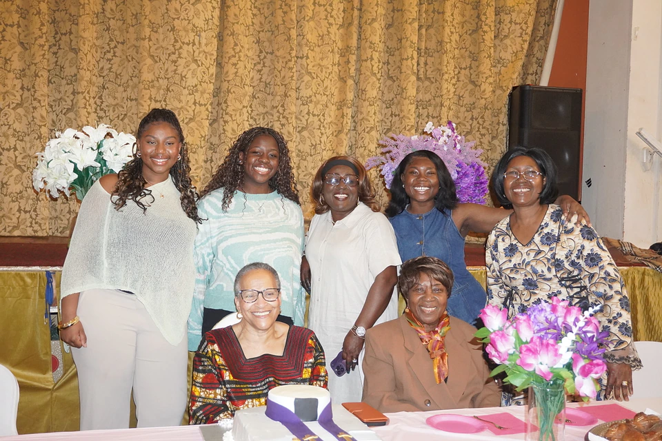 Church members gathered around a fellowship table