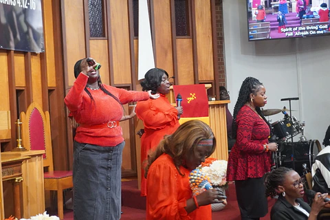 Worship singers raising their hands in song
