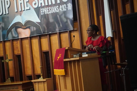 A speaker at the lectern beneath the Equip the Saints banner
