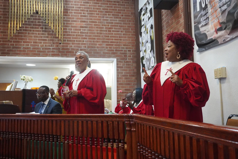 Robed choir members singing together