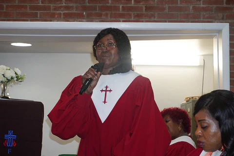 A choir member singing with a microphone